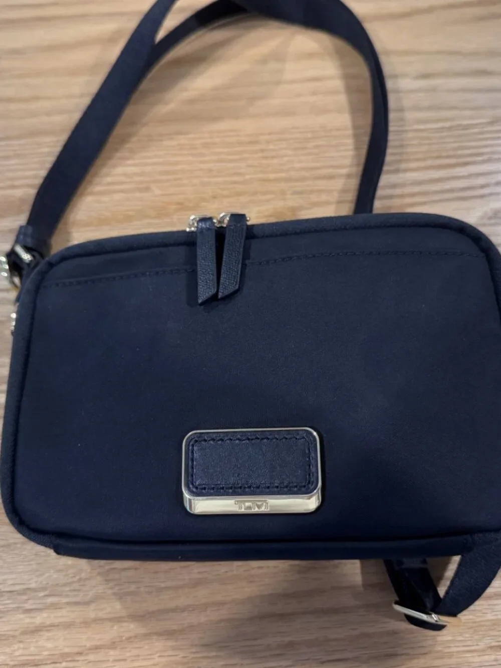 Authentic TUMI Voyageur Langley Crossbody in black with gold-tone hardware